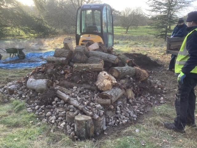 Stones and logs being moved by machinery
