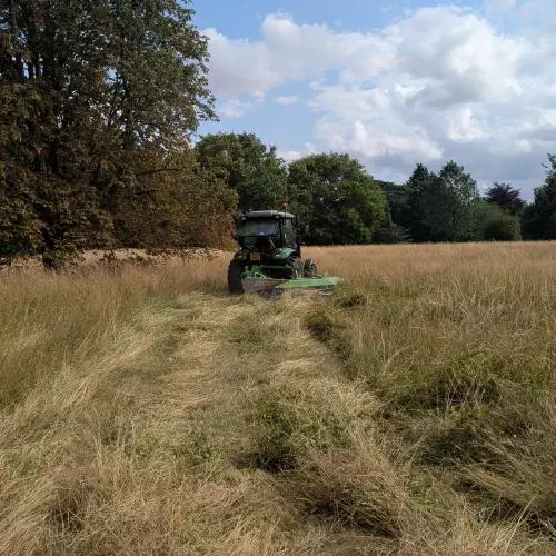 Tractor mowing wild flower meadow 2026