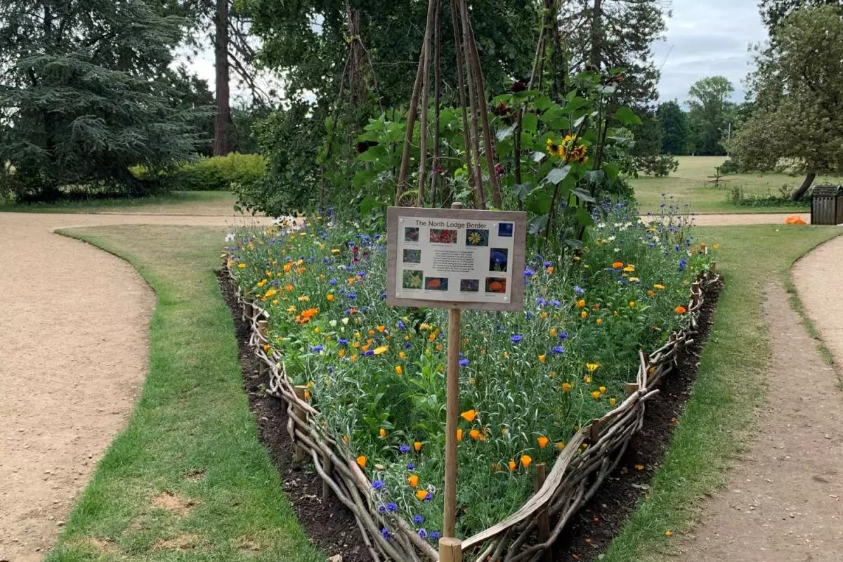 Flower bed at North Lodge planted by apprentices, with sign describing the plants used